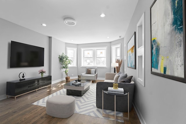 living area with recessed lighting, wood finished floors, and baseboards