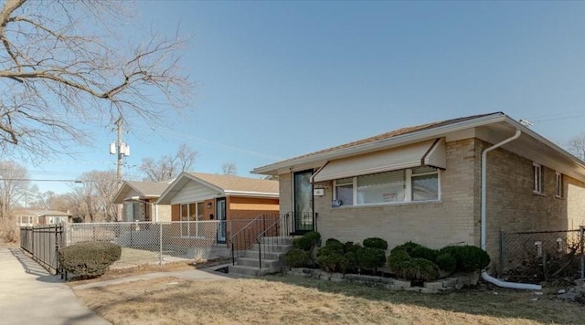 view of front of home with brick siding and fence