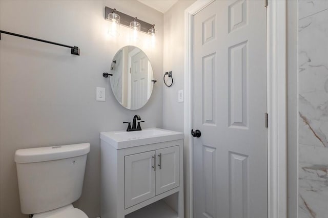 half bathroom with vanity and toilet