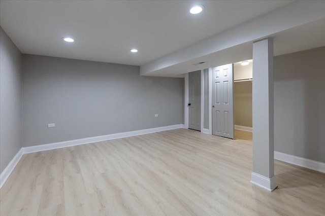 finished basement with recessed lighting, light wood-type flooring, and baseboards