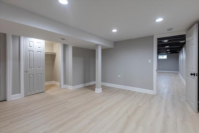 below grade area featuring recessed lighting, visible vents, light wood-style flooring, and baseboards