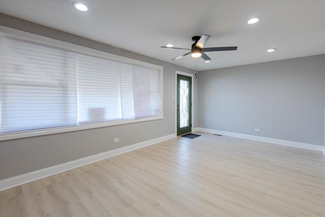 spare room with light wood-style floors, recessed lighting, ceiling fan, and baseboards