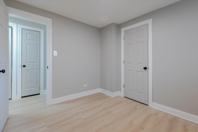 unfurnished room featuring light wood-style flooring and baseboards