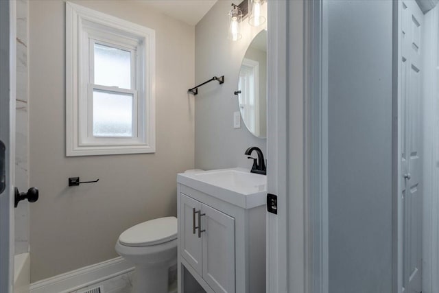 bathroom with baseboards, vanity, and toilet