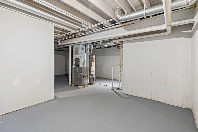 unfinished below grade area featuring heating unit and water heater