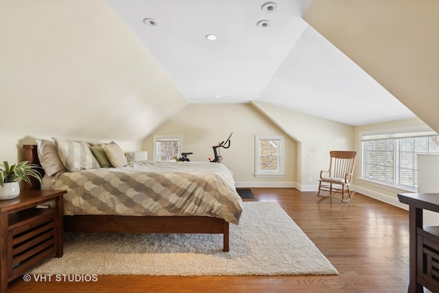 bedroom featuring lofted ceiling, baseboards, and wood finished floors