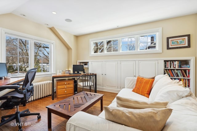 home office with light wood-type flooring, lofted ceiling, radiator heating unit, and recessed lighting