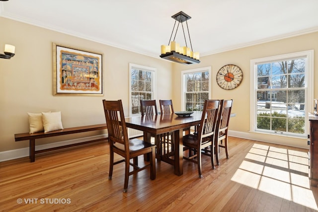 dining area with plenty of natural light, light wood-style flooring, and crown molding