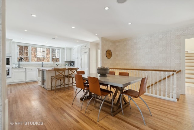 dining room featuring light wood-style floors, stairway, wallpapered walls, and recessed lighting