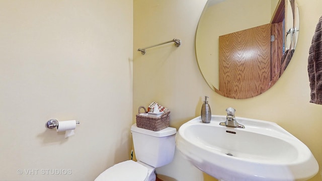 half bath with a sink and toilet