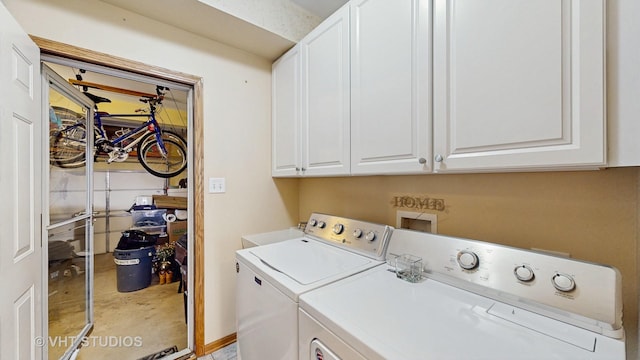 laundry area with cabinet space and separate washer and dryer