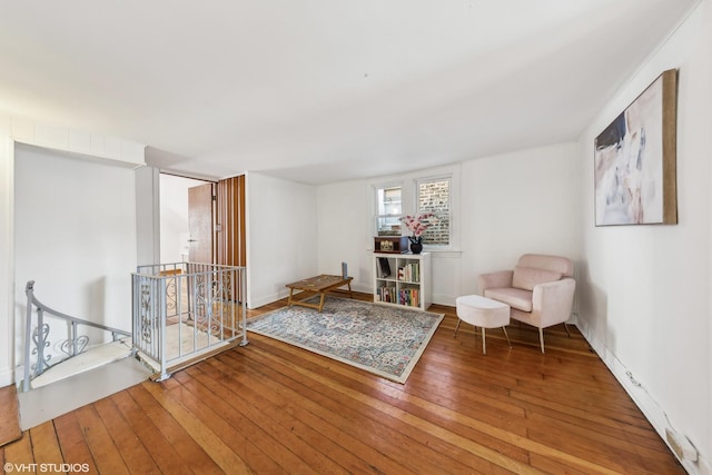 unfurnished room with an upstairs landing and wood finished floors