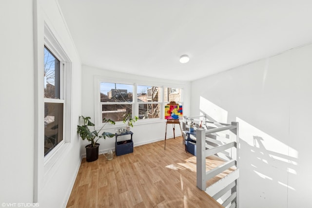 interior space featuring light wood-type flooring and baseboards