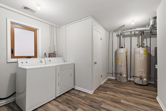 laundry room with laundry area, gas water heater, washing machine and clothes dryer, and visible vents