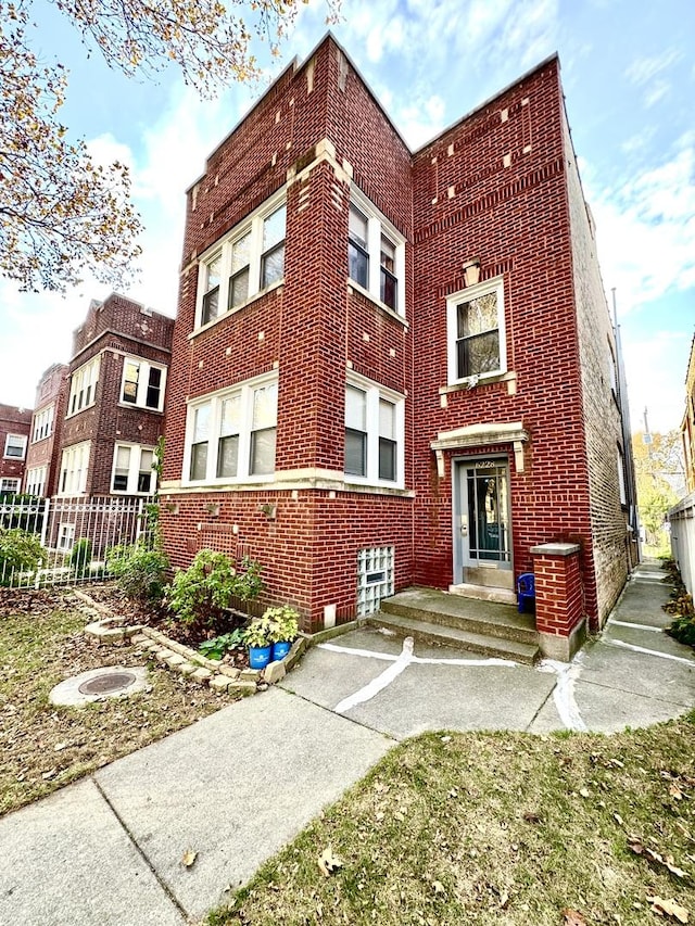 view of building exterior featuring fence