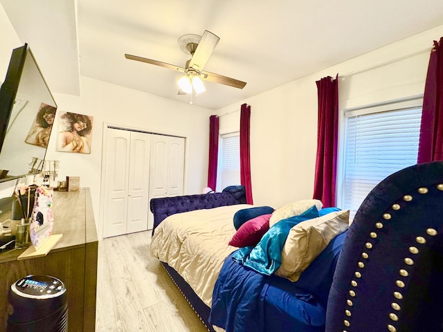 bedroom featuring a closet, a ceiling fan, and light wood-style floors