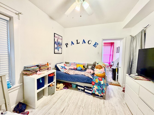 bedroom with ceiling fan and light wood-style flooring