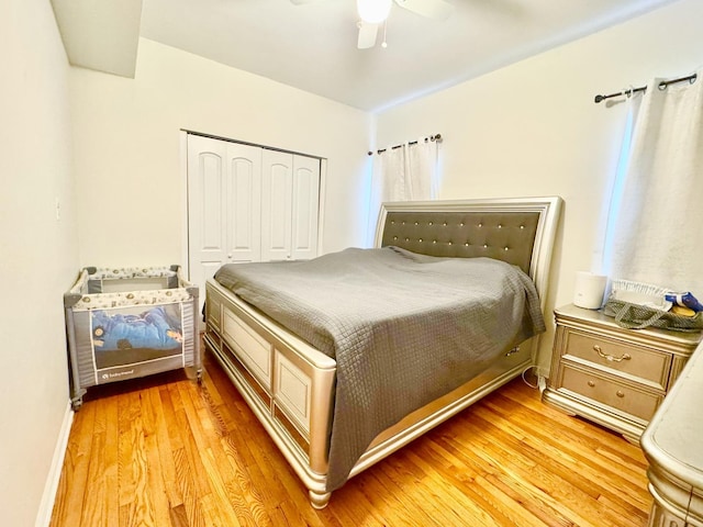 bedroom featuring a ceiling fan, a closet, and light wood finished floors