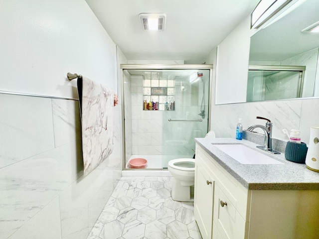 bathroom with tile walls, visible vents, toilet, a shower stall, and vanity