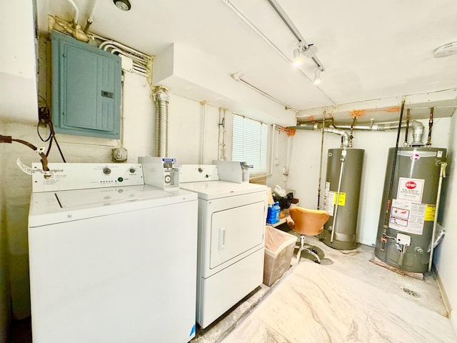 laundry area with laundry area, washing machine and dryer, electric panel, and gas water heater