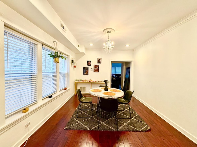 dining space featuring visible vents, baseboards, dark wood finished floors, ornamental molding, and a notable chandelier