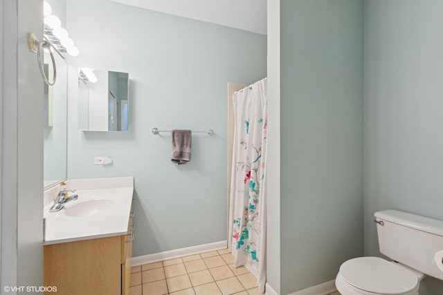 bathroom with baseboards, vanity, toilet, and tile patterned floors