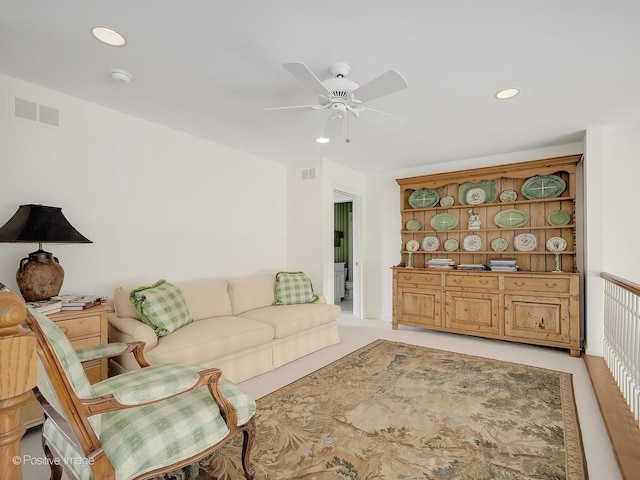 living area featuring recessed lighting, visible vents, and light carpet