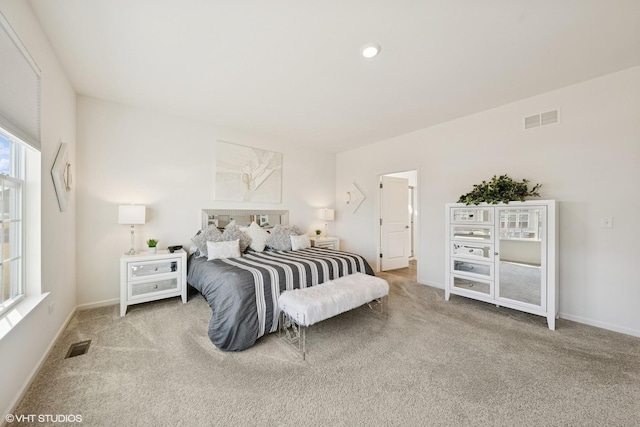 bedroom with carpet floors, recessed lighting, visible vents, and baseboards