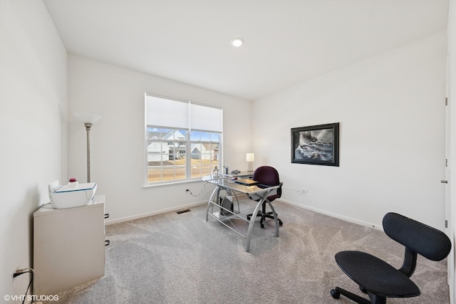 office space featuring carpet, visible vents, and baseboards