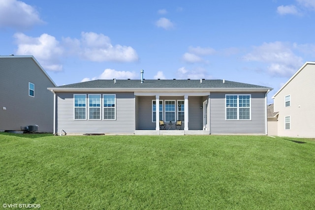 back of house featuring a lawn