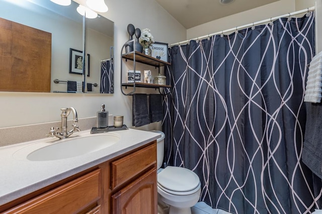 bathroom with toilet, tile patterned flooring, and vanity