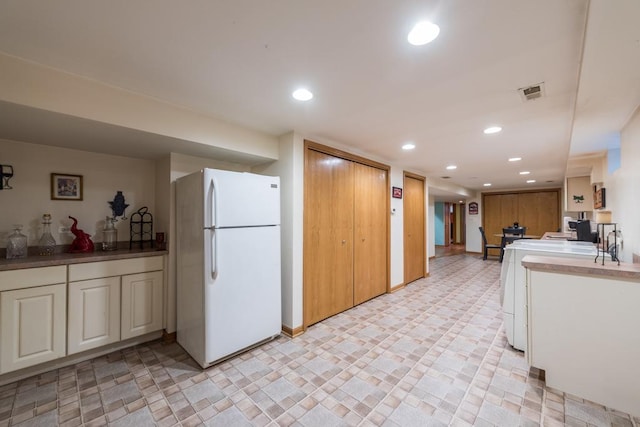 kitchen with visible vents, freestanding refrigerator, and recessed lighting