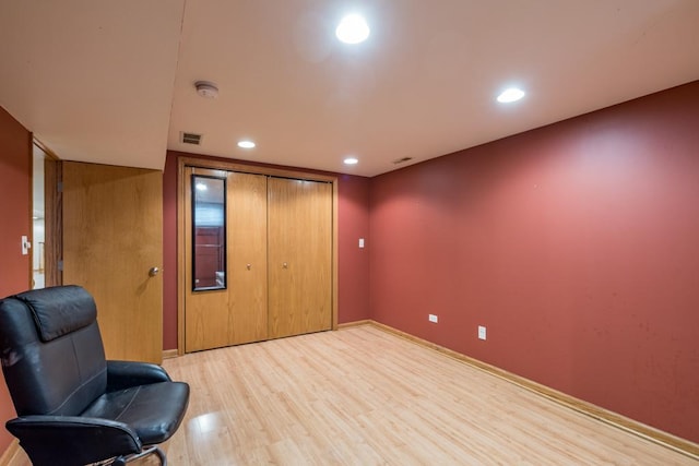 living area with recessed lighting, visible vents, baseboards, and wood finished floors