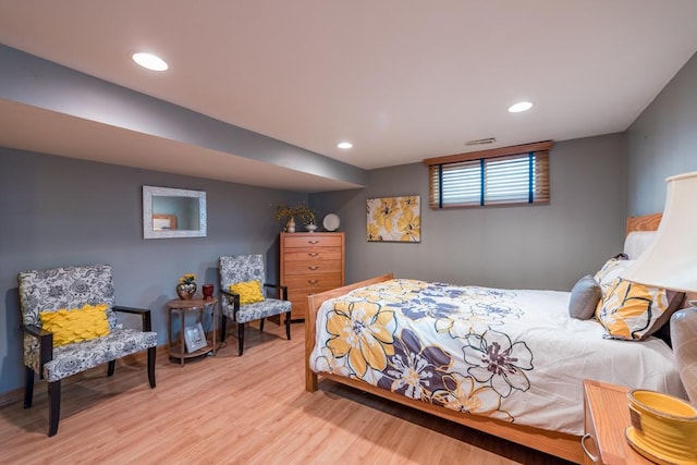 bedroom featuring wood finished floors, visible vents, and recessed lighting