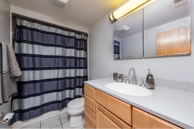 bathroom with toilet, vanity, tile patterned flooring, and visible vents