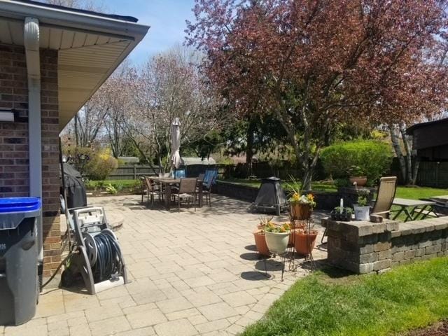 view of patio with fence and outdoor dining area