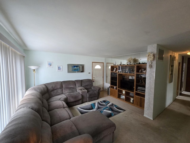 living area featuring carpet floors and visible vents