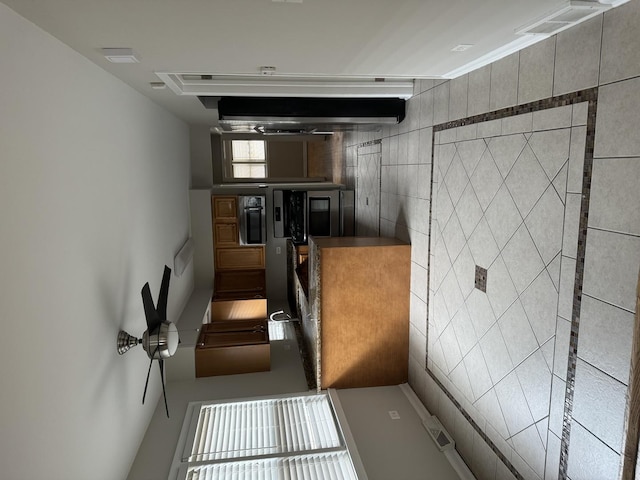 kitchen featuring visible vents and tile walls