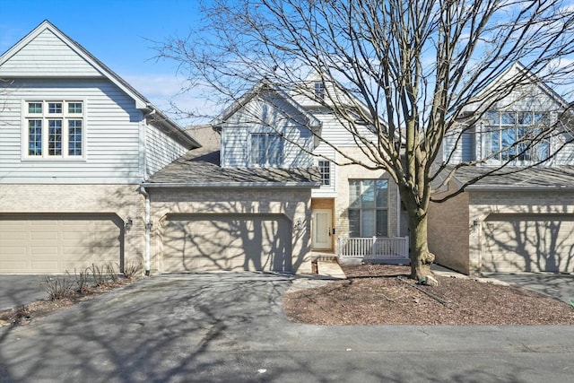 view of front of house with brick siding, driveway, and an attached garage