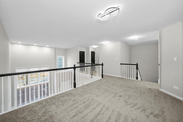 carpeted spare room with baseboards