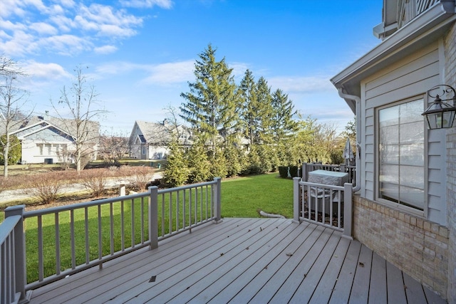 wooden deck featuring a yard