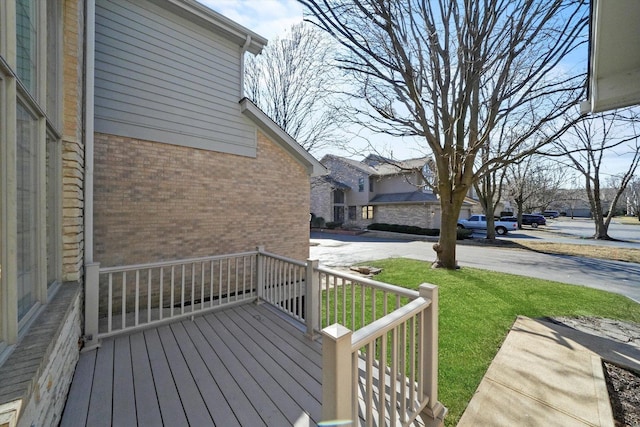 wooden deck featuring a yard