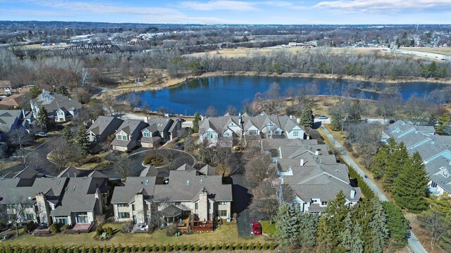 drone / aerial view with a residential view and a water view