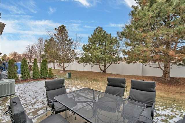 view of patio with outdoor dining space, a fenced backyard, and central AC unit