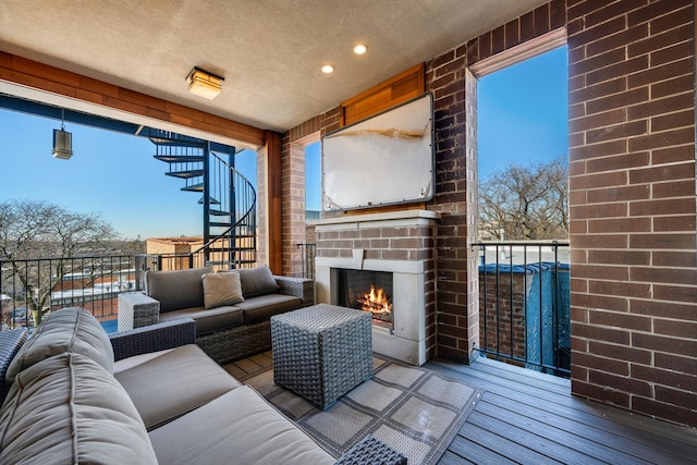 interior space with an outdoor living space with a fireplace and stairway