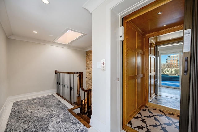 corridor with elevator, baseboards, a skylight, and crown molding