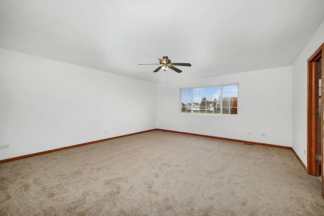 unfurnished room with carpet, a ceiling fan, and baseboards