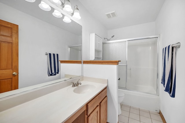 full bath featuring toilet, shower / bath combination with glass door, vanity, visible vents, and tile patterned floors