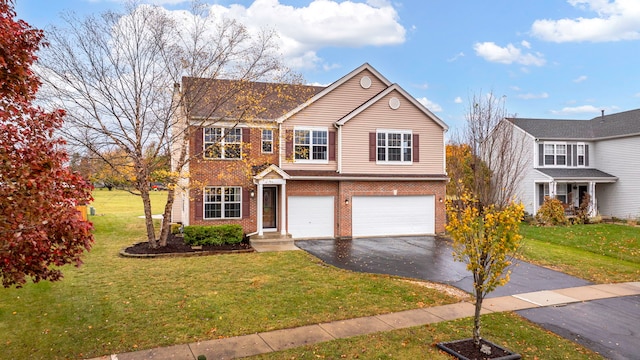 traditional-style house featuring a front lawn, aphalt driveway, and brick siding