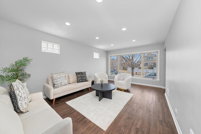 living room featuring dark wood-type flooring, recessed lighting, and baseboards